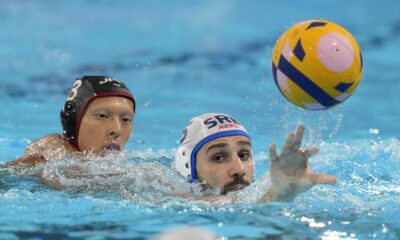 Serbia's Milos Cuk, right, and Japan's Taiyo Watanabe battle for the ball during the men's Water Polo Group B preliminary match between Serbia and Japan at the 2024 Summer Olympics, Sunday, July 28, 2024, in Saint-Denis, France. (AP Photo/Luca Bruno)