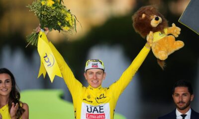 Tour de France winner Slovenia's Tadej Pogacar, wearing the overall leader's yellow jersey, celebrates on the podium after the twenty-first stage of the Tour de France cycling race, an individual time trial over 33.7 kilometers (20.9 miles) with start in Monaco and finish in Nice, France, Sunday, July 21, 2024. (AP Photo/Daniel Cole)