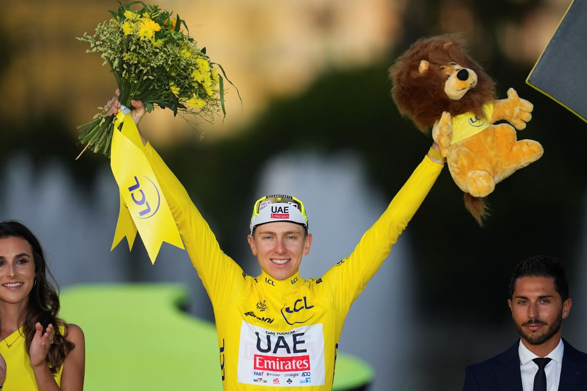 Tour de France winner Slovenia's Tadej Pogacar, wearing the overall leader's yellow jersey, celebrates on the podium after the twenty-first stage of the Tour de France cycling race, an individual time trial over 33.7 kilometers (20.9 miles) with start in Monaco and finish in Nice, France, Sunday, July 21, 2024. (AP Photo/Daniel Cole)