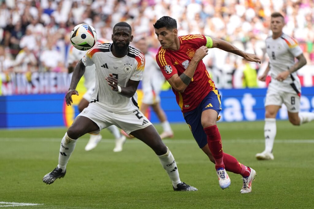 Germany's Antonio Ruediger, left, and Spain's Alvaro Morata vie for the ball during a quarter final match between Germany and Spain at the Euro 2024 soccer tournament in Stuttgart, Germany, Friday, July 5, 2024. (AP Photo/Matthias Schrader)