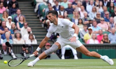 Novak Djokovic of Serbia plays a backhand return to Lorenzo Musetti of Italy during their semifinal match at the Wimbledon tennis championships in London, Friday, July 12, 2024. (AP Photo/Kirsty Wigglesworth)