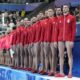 Serbia players listen their national anthem prior to the men's Water Polo Group B preliminary match between Serbia and Japan at the 2024 Summer Olympics, Sunday, July 28, 2024, in Saint-Denis, France. (AP Photo/Luca Bruno)