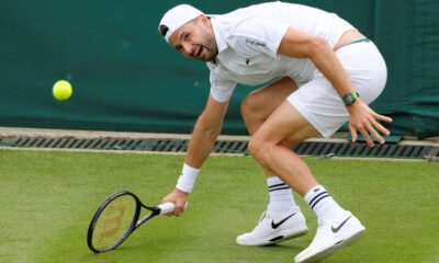 Grigor Dimitrov of Bulgaria plays a forehand return to Dusan Lajovic of Serbia during their first round match of the Wimbledon tennis championships in London, Monday, July 1, 2024. (AP Photo/Kirsty Wigglesworth)