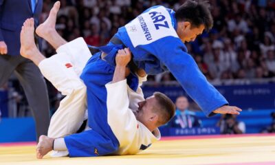 Serbia's Strahinja Buncic and Kazakhstan's Gusman Kyrgyzbayev compete during their men -66 kg bronze medal final match in team judo competition at Champ-de-Mars Arena during the 2024 Summer Olympics, Sunday, July 28, 2024, in Paris, France. (AP Photo/Eugene Hoshiko)