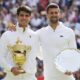 Carlos Alcaraz, left, of Spain holds his trophy after defeating Novak Djokovic, right, of Serbia in the men's singles final at the Wimbledon tennis championships in London, Sunday, July 14, 2024.(AP Photo/Kirsty Wigglesworth)