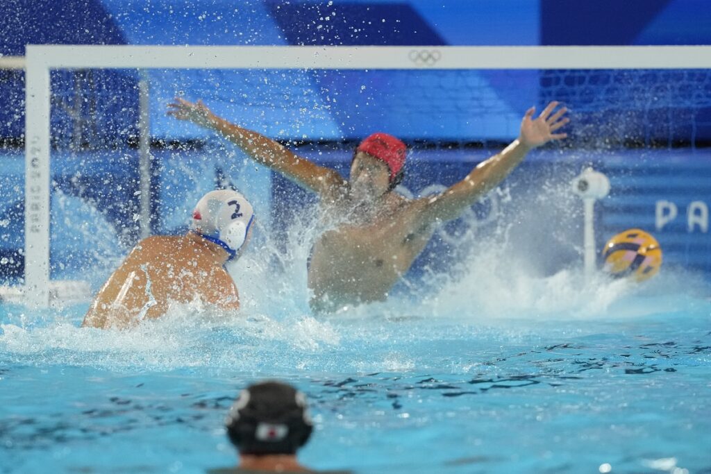 Serbia's Dusan Mandic scores a goal against Japan's goalkeeper Towa Nishimura during the men's Water Polo Group B preliminary match between Serbia and Japan at the 2024 Summer Olympics, Sunday, July 28, 2024, in Saint-Denis, France. (AP Photo/Luca Bruno)