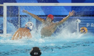 Serbia's Dusan Mandic scores a goal against Japan's goalkeeper Towa Nishimura during the men's Water Polo Group B preliminary match between Serbia and Japan at the 2024 Summer Olympics, Sunday, July 28, 2024, in Saint-Denis, France. (AP Photo/Luca Bruno)