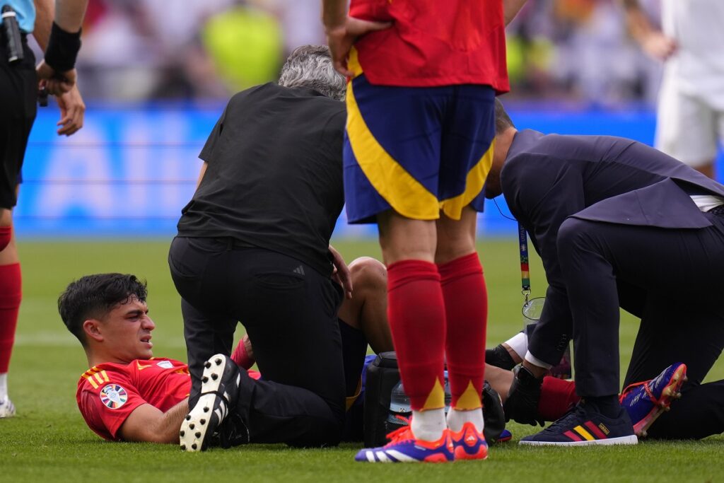 Spain's Pedri is treated after suffering an injury during a quarter final match between Germany and Spain at the Euro 2024 soccer tournament in Stuttgart, Germany, Friday, July 5, 2024. (AP Photo/Manu Fernandez)