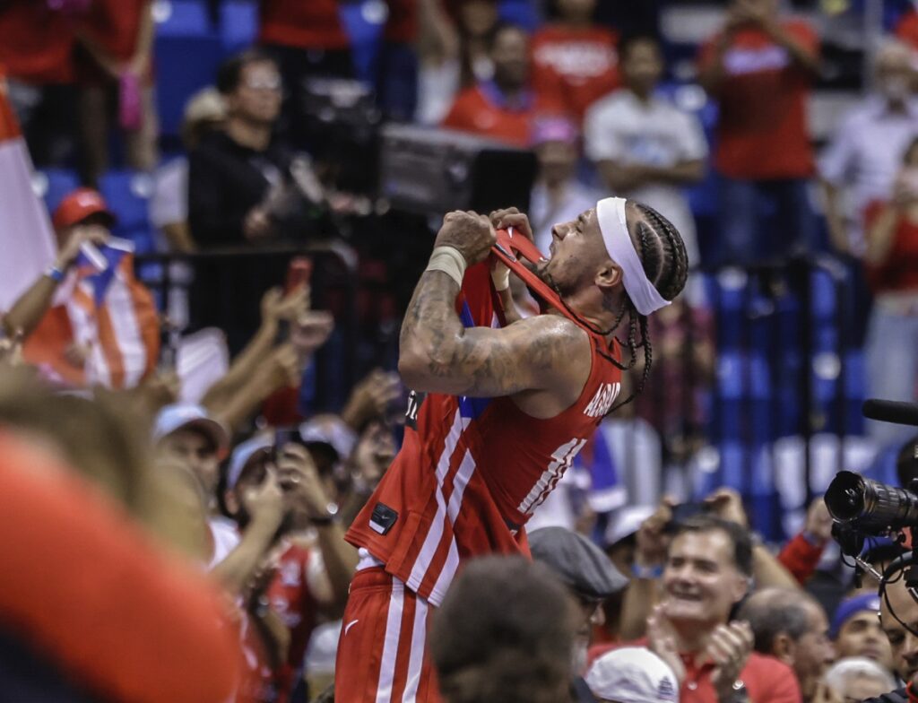 Puerto Rico's Jose Alvarado celebrates after his team qualified for the Paris 2024 Olympics after eliminating Lithuania in a FIBA Olympic Qualifying basketball final in San Juan, Puerto Rico, Sunday, July 7, 2024. (AP Photo/Alejandro Granadillo)