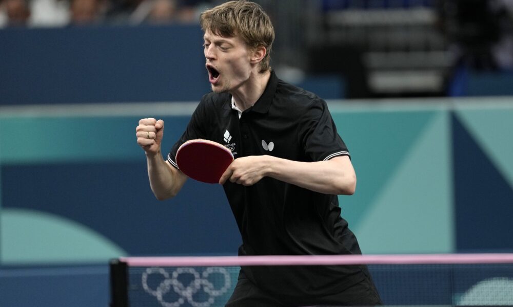 Denmark's Anders Lind reacts after a winning point against Portugal's Marcos Freitas during a men's singles round of 64 table tennis game at the 2024 Summer Olympics, Monday, July 29, 2024, in Paris, France. (AP Photo/Petros Giannakouris)