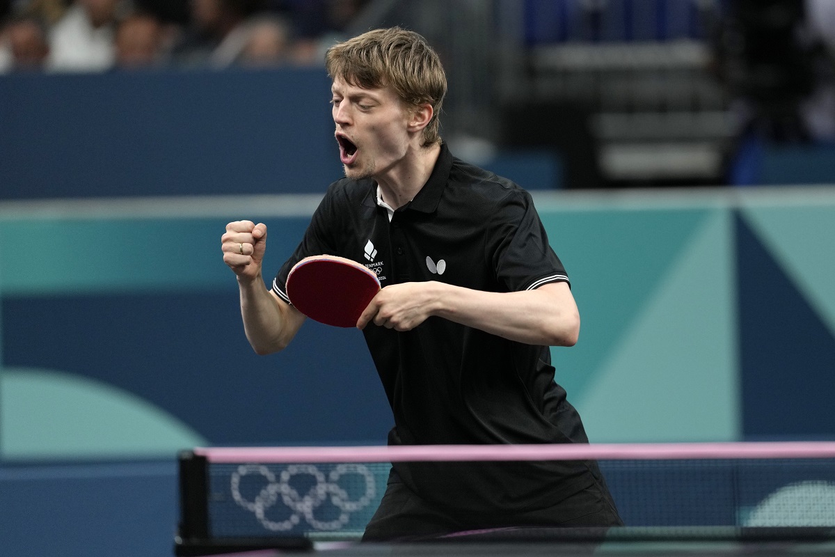 Denmark's Anders Lind reacts after a winning point against Portugal's Marcos Freitas during a men's singles round of 64 table tennis game at the 2024 Summer Olympics, Monday, July 29, 2024, in Paris, France. (AP Photo/Petros Giannakouris)