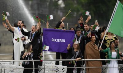 Team Algeria wave flags in Paris, France, during the opening ceremony of the 2024 Summer Olympics, Friday, July 26, 2024. (AP Photo/Kirsty Wigglesworth)