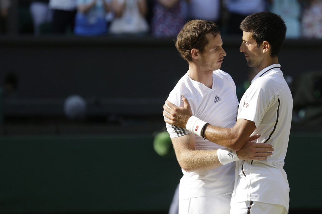 FILE - Andy Murray of Britain, left, is congratulated by Novak Djokovic of Serbia after he won the Men's singles final match at the All England Lawn Tennis Championships in Wimbledon, London, Sunday, July 7, 2013. Murray will play only doubles at his last appearance at the All England Club following his withdrawal from singles after back surgery. (AP Photo/Anja Niedringhaus, Pool, File)