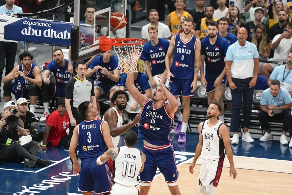 Serbia's Nikola Jokic tries to score during an exhibition basketball match between Serbia and the United States at the USA Basketball Showcase, ahead of the 2024 Paris Olympic basketball tournament, in Abu Dhabi, United Arab Emirates, Wednesday, July 17, 2024. (AP Photo/Altaf Qadri)