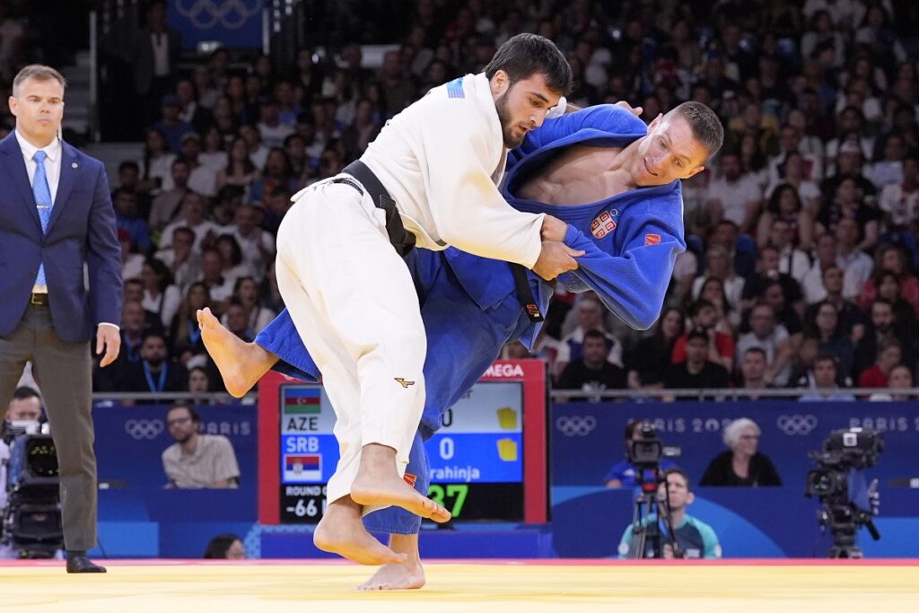 Azerbaijan's Yashar Najafov and Serbia's Strahinja Buncic, right, compete during their men -66 kg elimination round match in team judo competition at Champ-de-Mars Arena during the 2024 Summer Olympics, Sunday, July 28, 2024, in Paris, France. (AP Photo/Eugene Hoshiko)