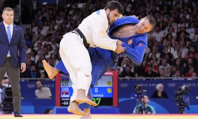 Azerbaijan's Yashar Najafov and Serbia's Strahinja Buncic, right, compete during their men -66 kg elimination round match in team judo competition at Champ-de-Mars Arena during the 2024 Summer Olympics, Sunday, July 28, 2024, in Paris, France. (AP Photo/Eugene Hoshiko)