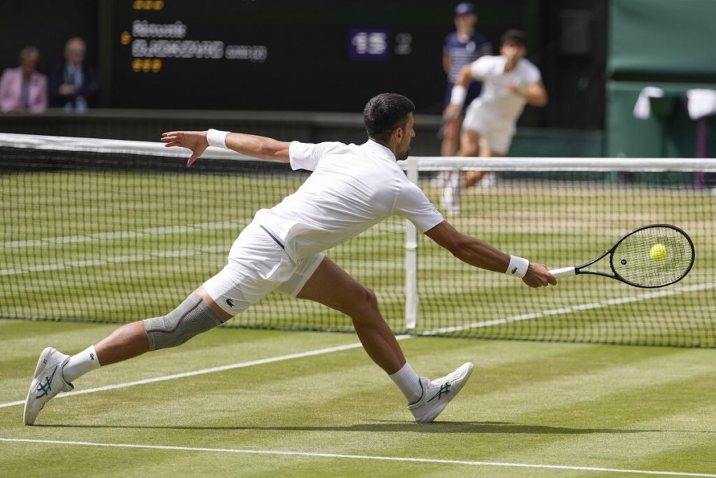 Novak Djokovic of Serbia plays a forehand return to Carlos Alcaraz of Spain during the men's singles final at the Wimbledon tennis championships in London, Sunday, July 14, 2024. (AP Photo/Alberto Pezzali)