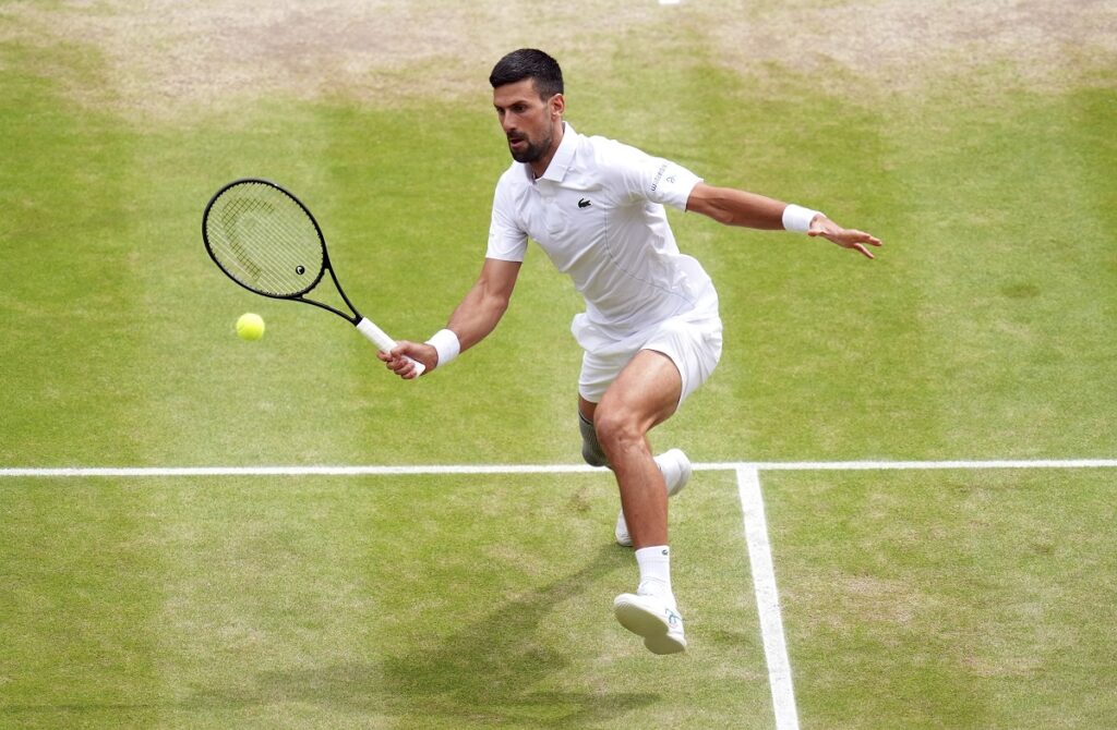 Novak Djokovic of Serbia plays a forehand return to Carlos Alcaraz of Spain during the men's singles final at the Wimbledon tennis championships in London, Sunday, July 14, 2024. (John Walton/PA via AP)