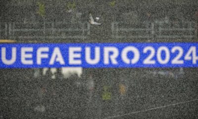 A pigeon flies through heavy rainfall before a semifinal match between the Netherlands and England at the Euro 2024 soccer tournament in Dortmund, Germany, Wednesday, July 10, 2024. (AP Photo/Andreea Alexandru)