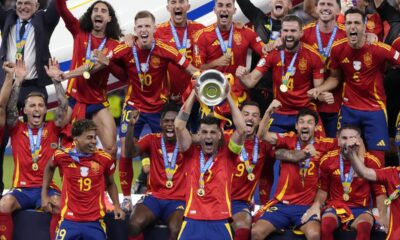 Spain's Alvaro Morata holds the trophy as he celebrates with his teammates after winning the final match between Spain and England at the Euro 2024 soccer tournament in Berlin, Germany, Sunday, July 14, 2024. Spain won 2-1. (AP Photo/Frank Augstein)