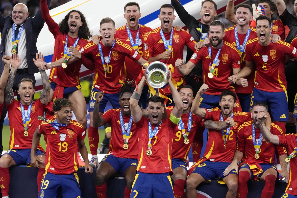 Spain's Alvaro Morata holds the trophy as he celebrates with his teammates after winning the final match between Spain and England at the Euro 2024 soccer tournament in Berlin, Germany, Sunday, July 14, 2024. Spain won 2-1. (AP Photo/Frank Augstein)