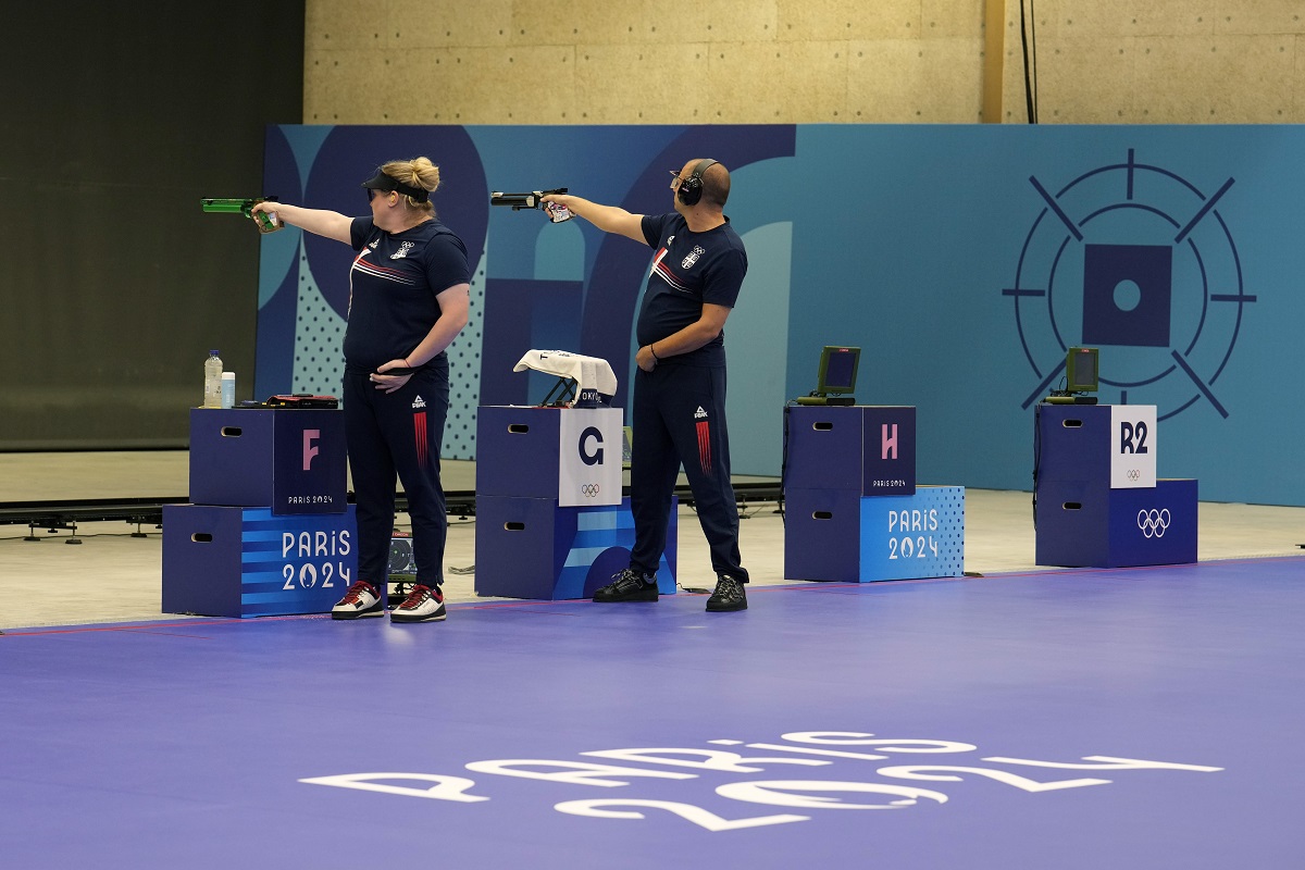 Serbia's Zorana Arunovic, left, and Damir Mikec compete in the 10m air pistol mixed team gold medal event at the 2024 Summer Olympics, Tuesday, July 30, 2024, in Chateauroux, France. (AP Photo/Manish Swarup)