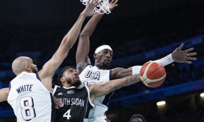 Carlik Jones, of South Sudan, shoots between Derrick White, (8) and Jayson Tatum, of the United States, in a men's basketball game at the 2024 Summer Olympics, Wednesday, July 31, 2024, in Villeneuve-d'Ascq, France. (AP Photo/Mark J. Terrill)