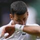 Novak Djokovic of Serbia wipes the sweat from his face during his match against Carlos Alcaraz of Spain in the men's singles final at the Wimbledon tennis championships in London, Sunday, July 14, 2024. (AP Photo/Alberto Pezzali)