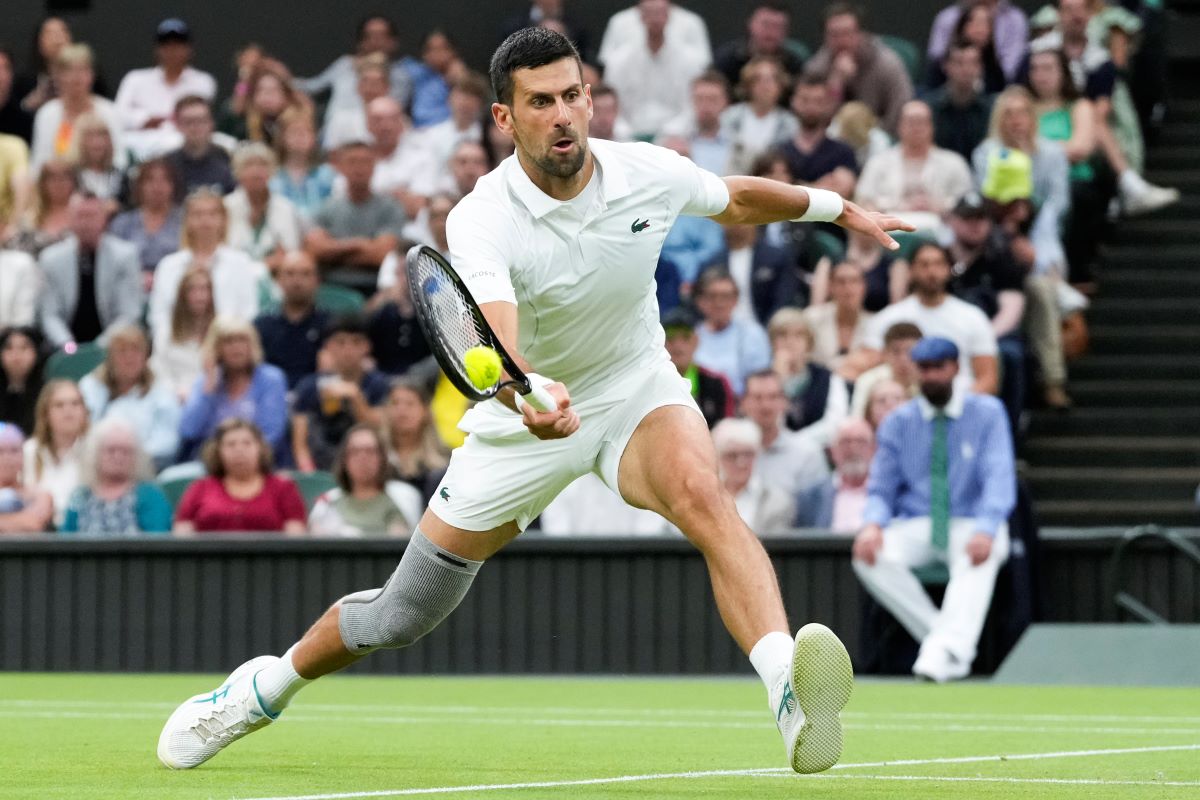 Novak Djokovic of Serbia plays a forehand return to Hulger Rune of Denmark during their fourth round match at the Wimbledon tennis championships in London, Monday, July 8, 2024. (AP Photo/Kirsty Wigglesworth)