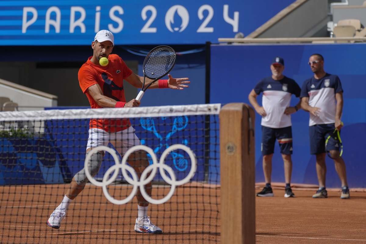 Novak Djokovic of Serbia returns the ball during a practice session ahead of the tennis competition, at the 2024 Summer Olympics, Thursday, July 25, 2024, in Paris, France. (AP Photo/Andy Wong)