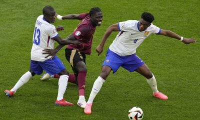 Belgium's Amadou Onana is challenged by N'Golo Kante of France and Aurelien Tchouameni of France during a round of sixteen match between France and Belgium at the Euro 2024 soccer tournament in Duesseldorf, Germany, Monday, July 1, 2024. (AP Photo/Andreea Alexandru)