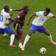 Belgium's Amadou Onana is challenged by N'Golo Kante of France and Aurelien Tchouameni of France during a round of sixteen match between France and Belgium at the Euro 2024 soccer tournament in Duesseldorf, Germany, Monday, July 1, 2024. (AP Photo/Andreea Alexandru)