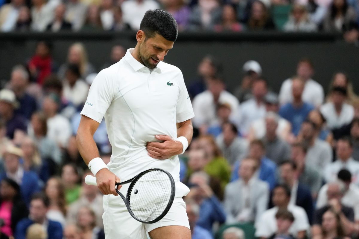 Novak Djokovic of Serbia reacts during his fourth round match against Hulger Rune of Denmark at the Wimbledon tennis championships in London, Monday, July 8, 2024. (AP Photo/Kirsty Wigglesworth)