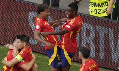 Spain's Lamine Yamal, top left celebrates with Spain's Nico Williams, top right and other team mates after Dani Olmo scored the opening goal during a quarter final match between Germany and Spain at the Euro 2024 soccer tournament in Stuttgart, Germany, Friday, July 5, 2024. (AP Photo/Michael Probst)