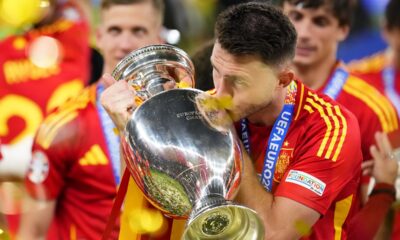 Spain's Aymeric Laporte kisses the trophy after winning the final match between Spain and England at the Euro 2024 soccer tournament in Berlin, Germany, Sunday, July 14, 2024. Spain won 2-1. (AP Photo/Manu Fernandez)