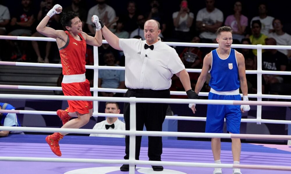 China's Yang Wenlu celebrates after defeating Serbia's Natalia Shadrina in their women's 60 kg quarterfinal boxing match at the 2024 Summer Olympics, Wednesday, July 31, 2024, in Paris, France. (AP Photo/John Locher)