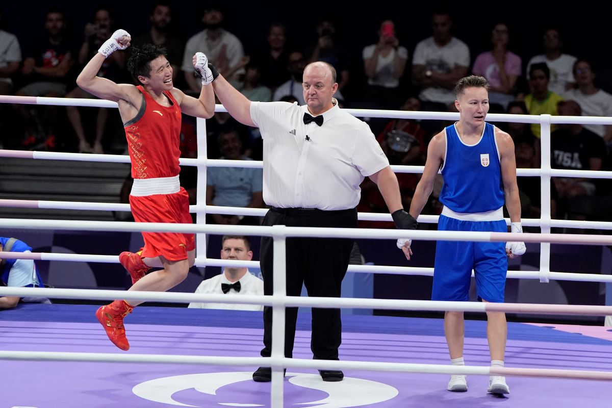 China's Yang Wenlu celebrates after defeating Serbia's Natalia Shadrina in their women's 60 kg quarterfinal boxing match at the 2024 Summer Olympics, Wednesday, July 31, 2024, in Paris, France. (AP Photo/John Locher)