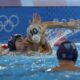 Serbia's Nemanja Ubovic, center left, and Australia's Marcus Berehulak, center right, battle for position during a men's water polo Group B preliminary match between Australia and Serbia at the 2024 Summer Olympics, Tuesday, July 30, 2024, in Saint-Denis, France. (AP Photo/Luca Bruno)