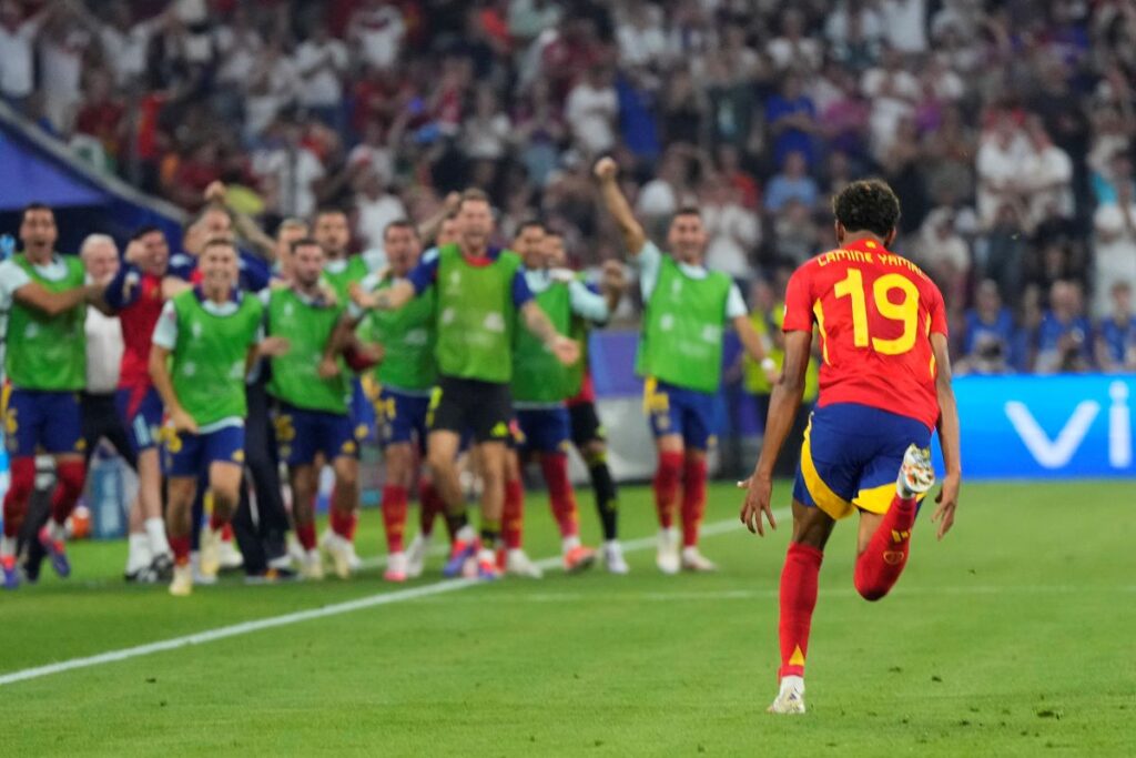 Spain's Lamine Yamal celebrates after scoring his side's first goal during a semifinal match between Spain and France at the Euro 2024 soccer tournament in Munich, Germany, Tuesday, July 9, 2024. (AP Photo/Manu Fernandez)