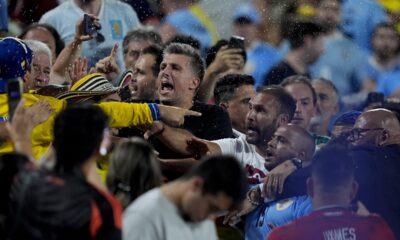 Uruguay's players argue with fans at the end of a Copa America semifinal soccer match against Colombia in Charlotte, N.C., Wednesday, July 10, 2024. (AP Photo/Julia Nikhinson)