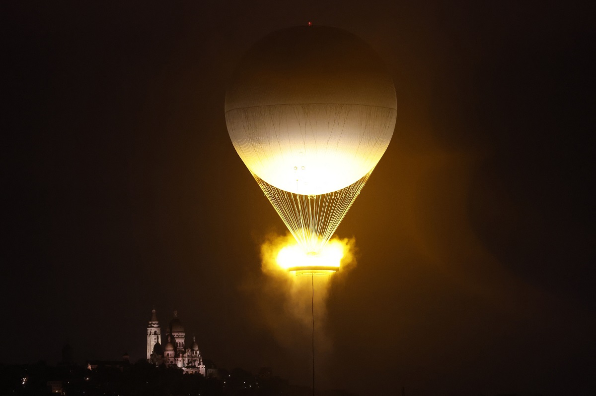 The cauldron, with the Olympic flame lit, lifts off while attached to a balloon, in Paris, France, during the opening ceremony of the 2024 Summer Olympics, Friday, July 26, 2024. (Peter Cziborra/Pool Photo via AP)