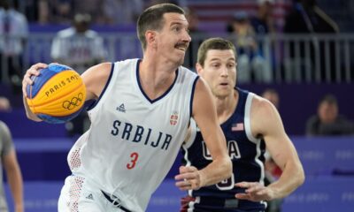 Strahinja Stojacic of Serbia drives past Jimmer Fredette of the United States in the men's 3x3 basketball pool round match between Serbia and the United States at the 2024 Summer Olympics, Tuesday, July 30, 2024, in Paris, France. (AP Photo/Rebecca Blackwell)