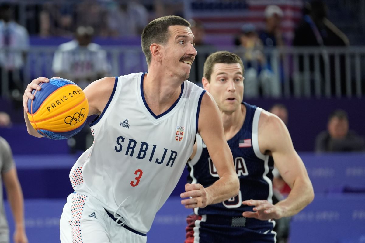 Strahinja Stojacic of Serbia drives past Jimmer Fredette of the United States in the men's 3x3 basketball pool round match between Serbia and the United States at the 2024 Summer Olympics, Tuesday, July 30, 2024, in Paris, France. (AP Photo/Rebecca Blackwell)