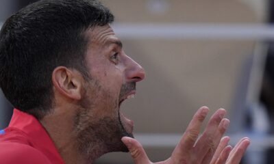 Novak Djokovic of Serbia reacts during a break as he plays against Lorenzo Musetti of Italy during their men's singles semifinals tennis match, at the 2024 Summer Olympics, Friday, Aug. 2, 2024, at the Roland Garros stadium in Paris, France. (AP Photo/Andy Wong)