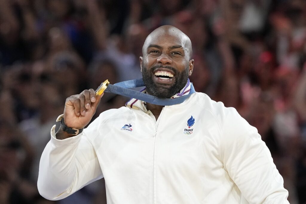 Golden medalist France's Teddy Riner poses on the podium of the judo men's +100 kg event in the team judo competition, at Champ-de-Mars Arena, during the 2024 Summer Olympics, Friday, Aug. 2, 2024, in Paris, France. (AP Photo/Eugene Hoshiko)