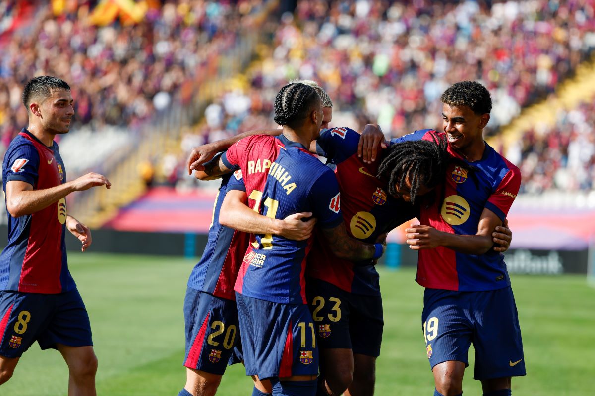 Barcelona's Jules Kounde (23) is congratulated after scoring his side's 3rd goal during the Spanish La Liga soccer match between FC Barcelona and Valladolid at the Olympic stadium in Barcelona, Spain, Saturday, Aug. 31, 2024. (AP Photo/Joan Monfort)