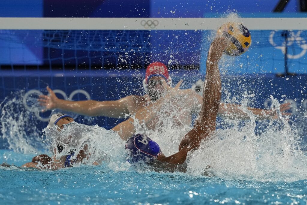 France's Thomas Vernoux makes an attempt to score during a men's water polo Group B preliminary match between Serbia and France, at the 2024 Summer Olympics, Saturday, Aug. 3, 2024, in Saint-Denis, France. (AP Photo/Luca Bruno)