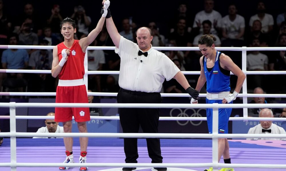 Taiwan's Lin Yu-ting celebrates after defeating Bulgaria's Svetlana Staneva in their women's 57 kg quarterfinal boxing match at the 2024 Summer Olympics, Sunday, Aug. 4, 2024, in Paris, France. (AP Photo/John Locher)