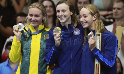 Australia's Ariarne Titmus, United States' Katie Ledecky and United States' Paige Madden celebrate with their medals during the awards ceremony for women's 800-meter freestyle the at the Summer Olympics in Nanterre, France, Saturday, Aug. 3, 2024. (AP Photo/Brynn Anderson)