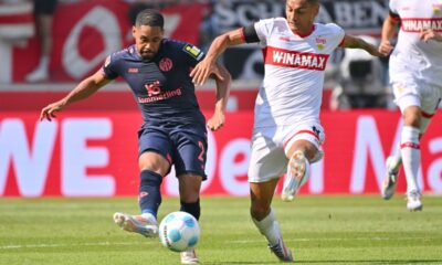 hilipp Mwene of Mainz, left, and Stuttgart's Enzo Millot challenge for the ball during the German Bundesliga soccer match between Stuttgart and Mainz in Stuttgart, Germany, Saturday, Aug. 31, 2024. (Jan-Philipp Strobel/dpa via AP)